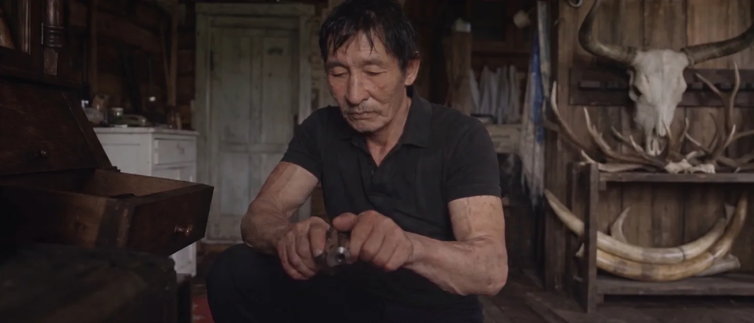 Ivanov checks his pistol, from Tusk Hunters